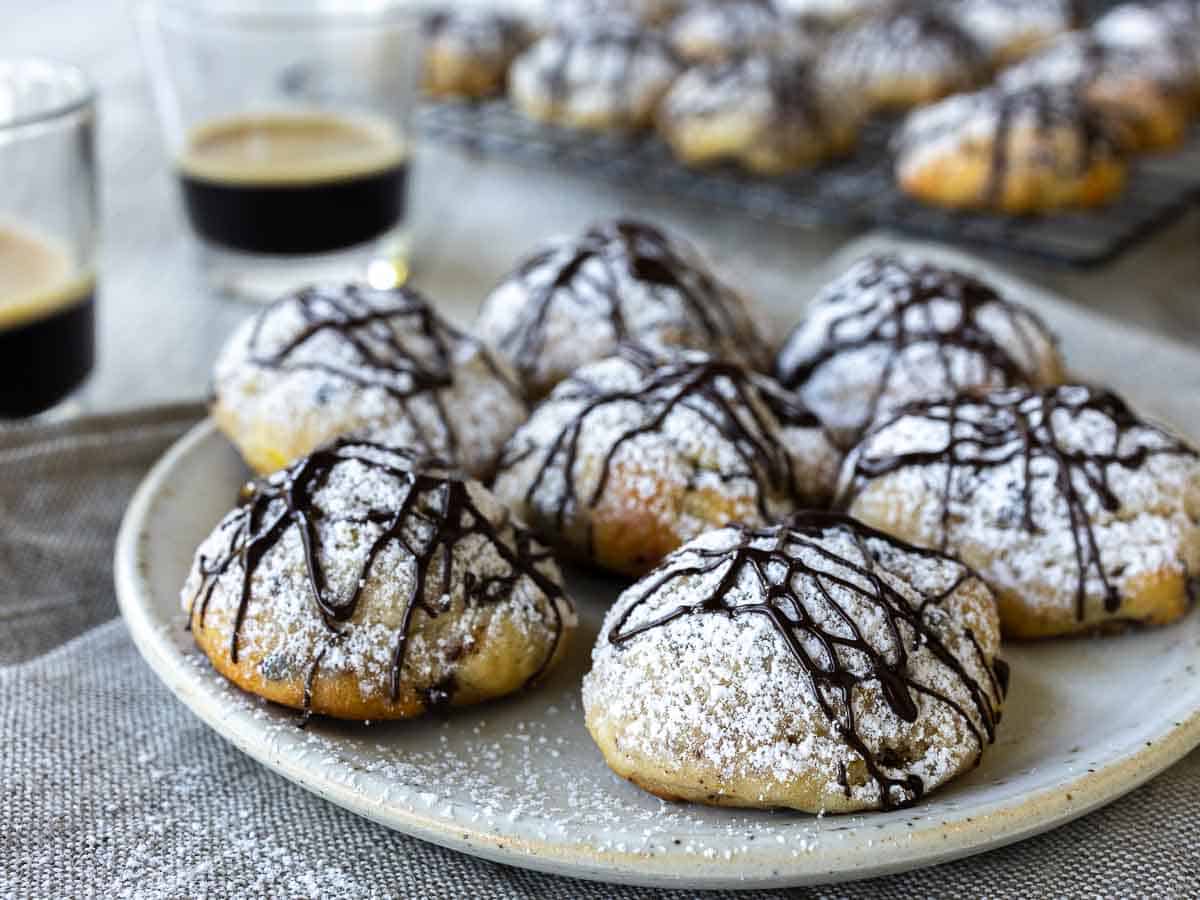 Cookies drizzled with chocolate on a plate.