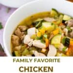 A bowl of chicken vegetable soup with bread.