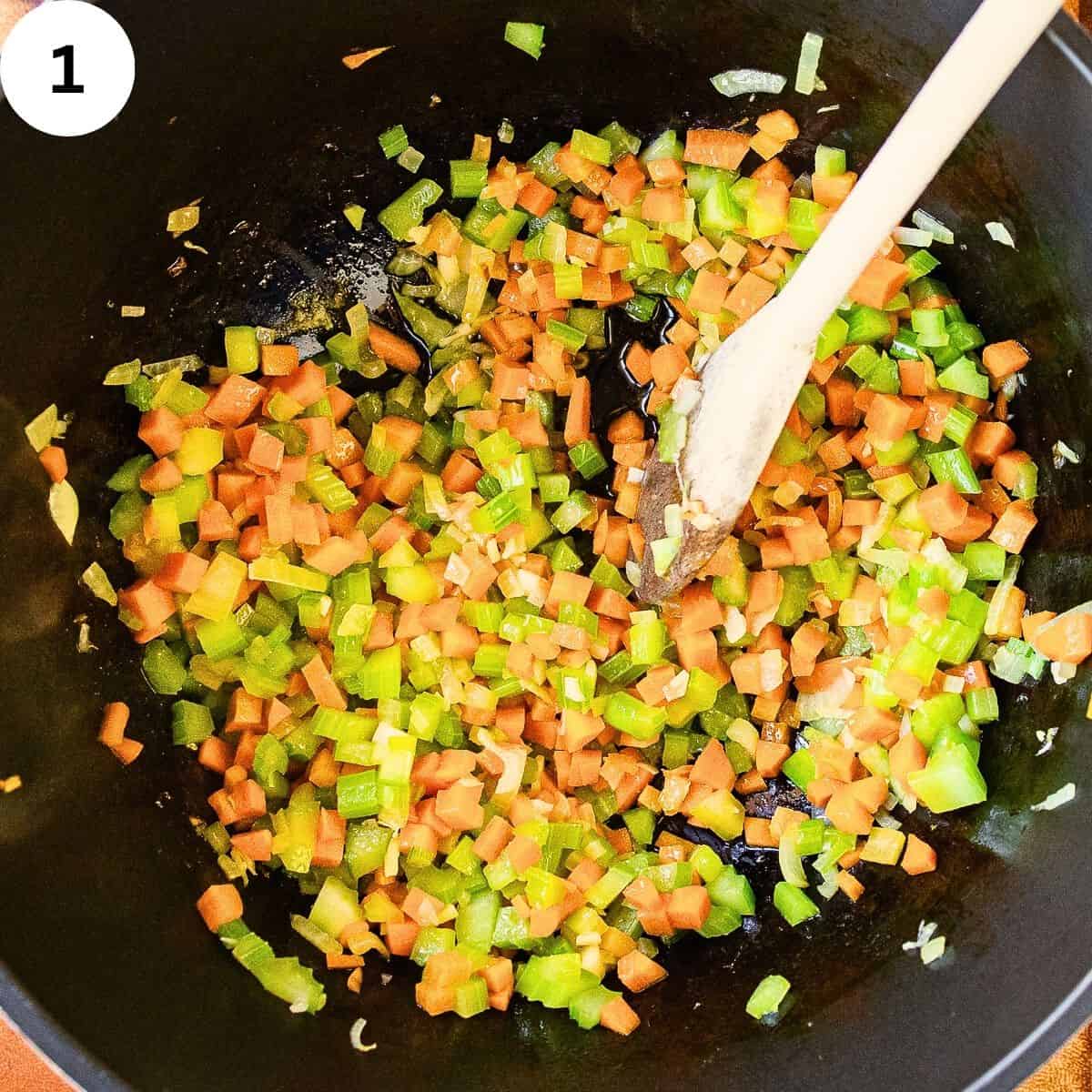 Frying chopped vegetables in a saucepan.