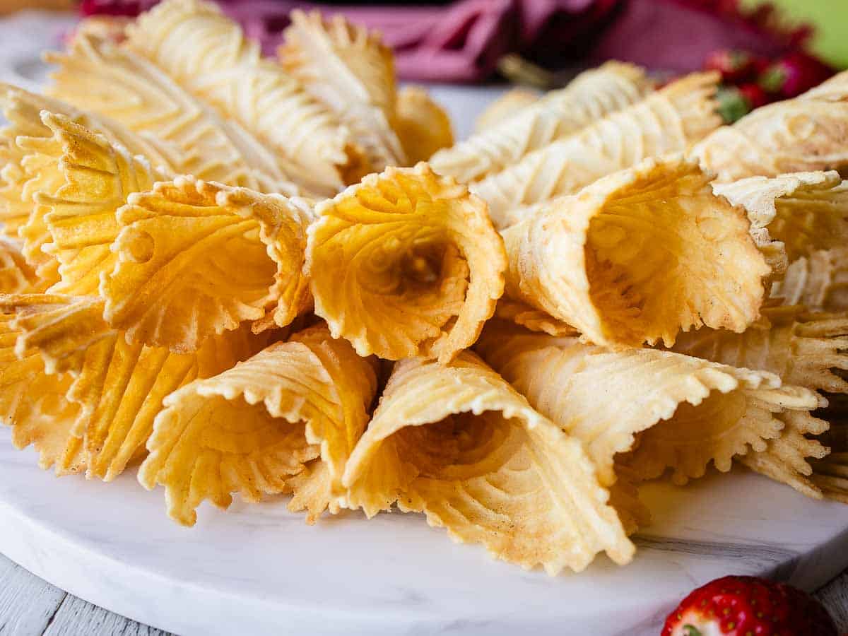 A side view of cone-shaped, crisp and thin waffle cookies.
