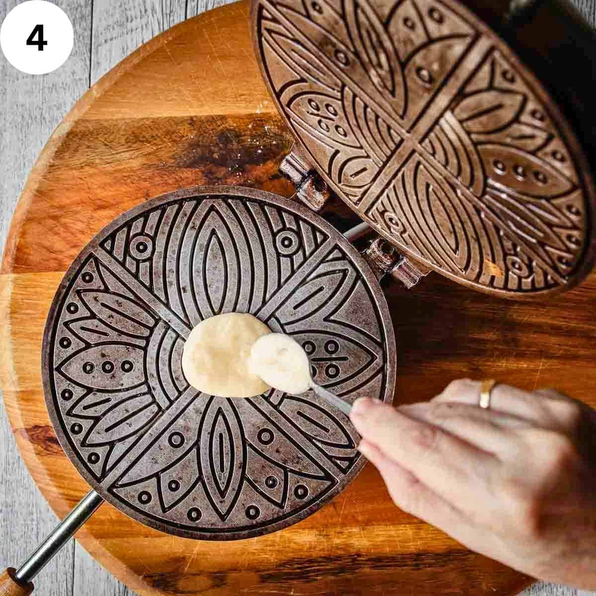 Spooning batter onto pizzelle iron.