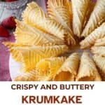 A plate of krumkake with strawberries around it.