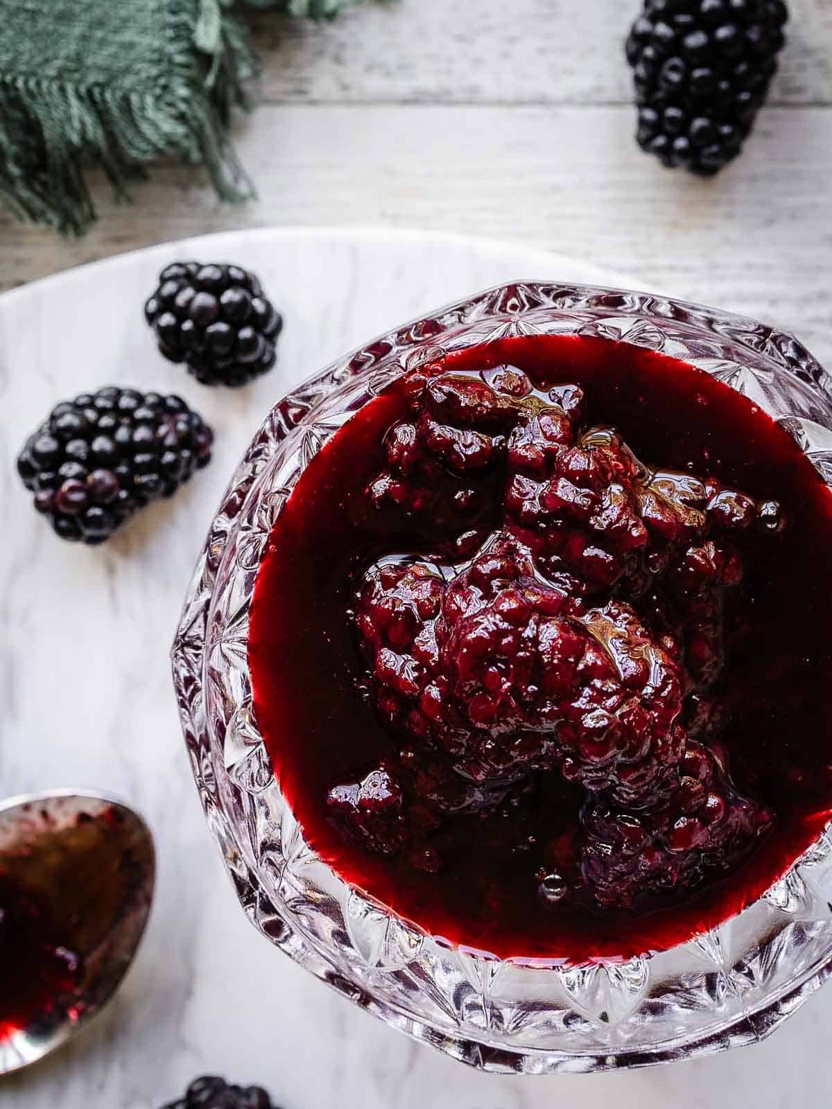Overhead view of a berry compote in a glass bowl.