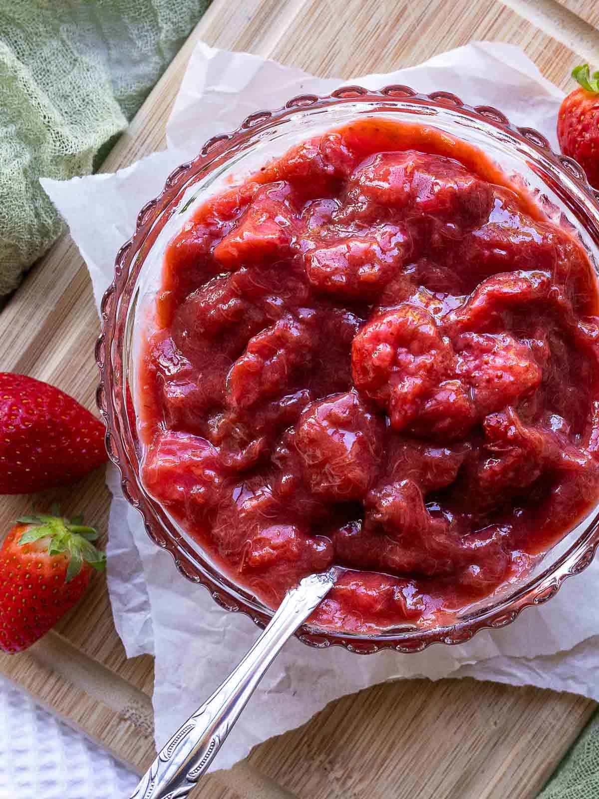 Rhubarb and strawberry sauce in a glass bowl viewed from above.