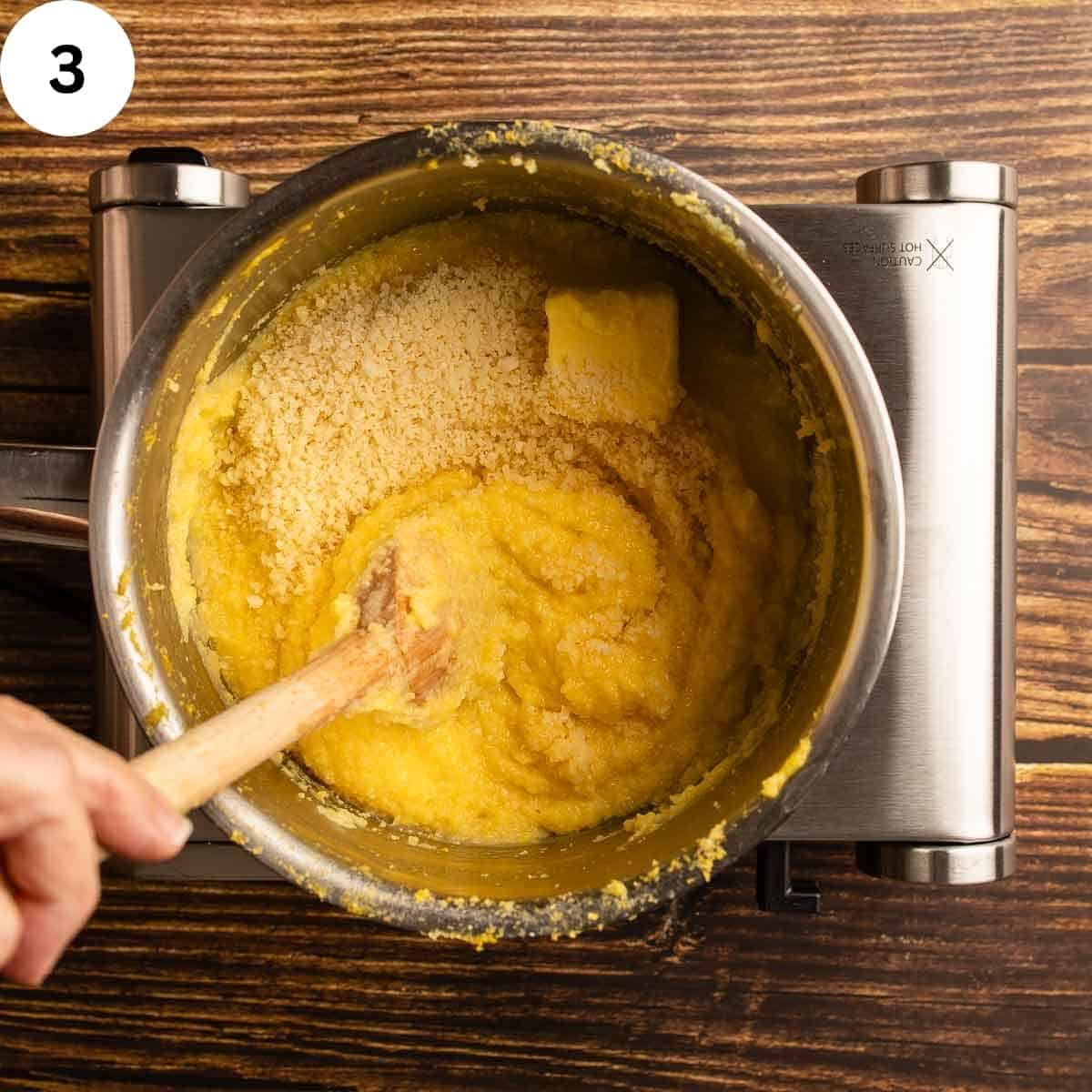 Stirring Parmigiano Reggiano cheese and butter into hot polenta.
