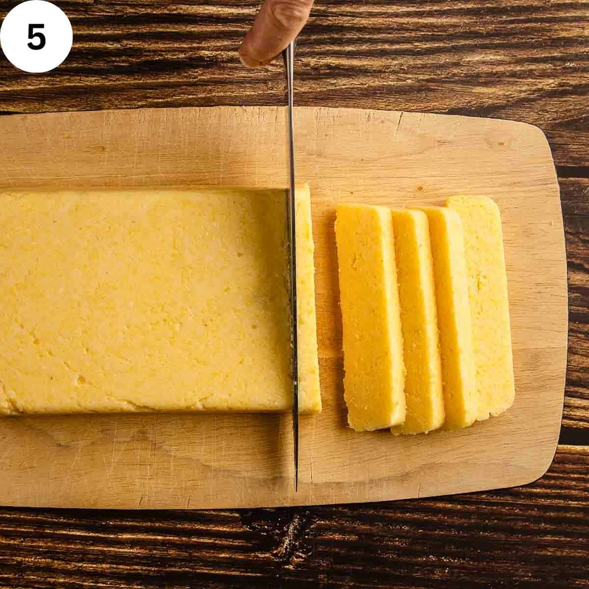 Slicing a block of hard polenta.