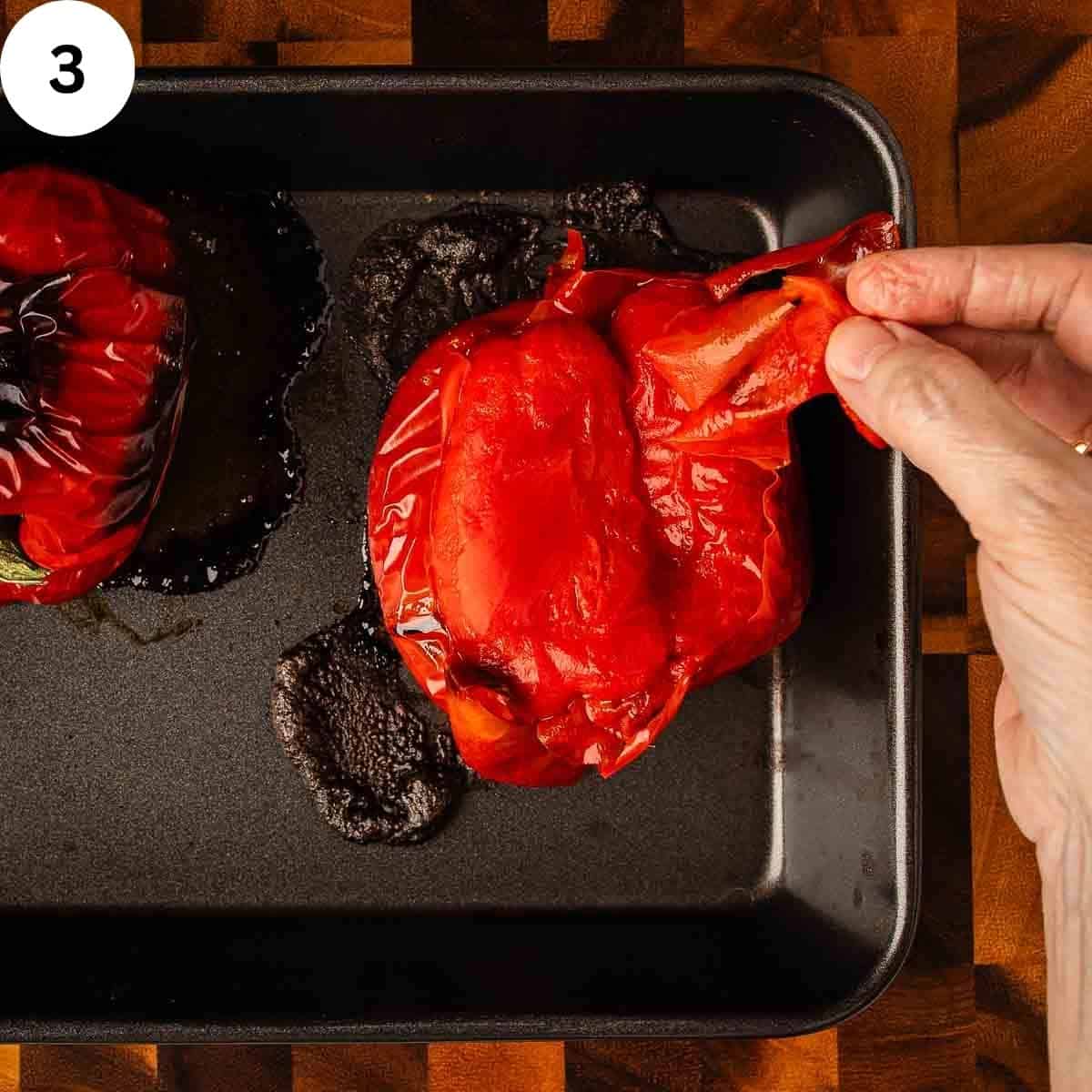 Peeling the skin off roasted bell peppers.