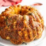 Garlic Monkey Bread baked in a bundt pan turned out onto a plate to serve.