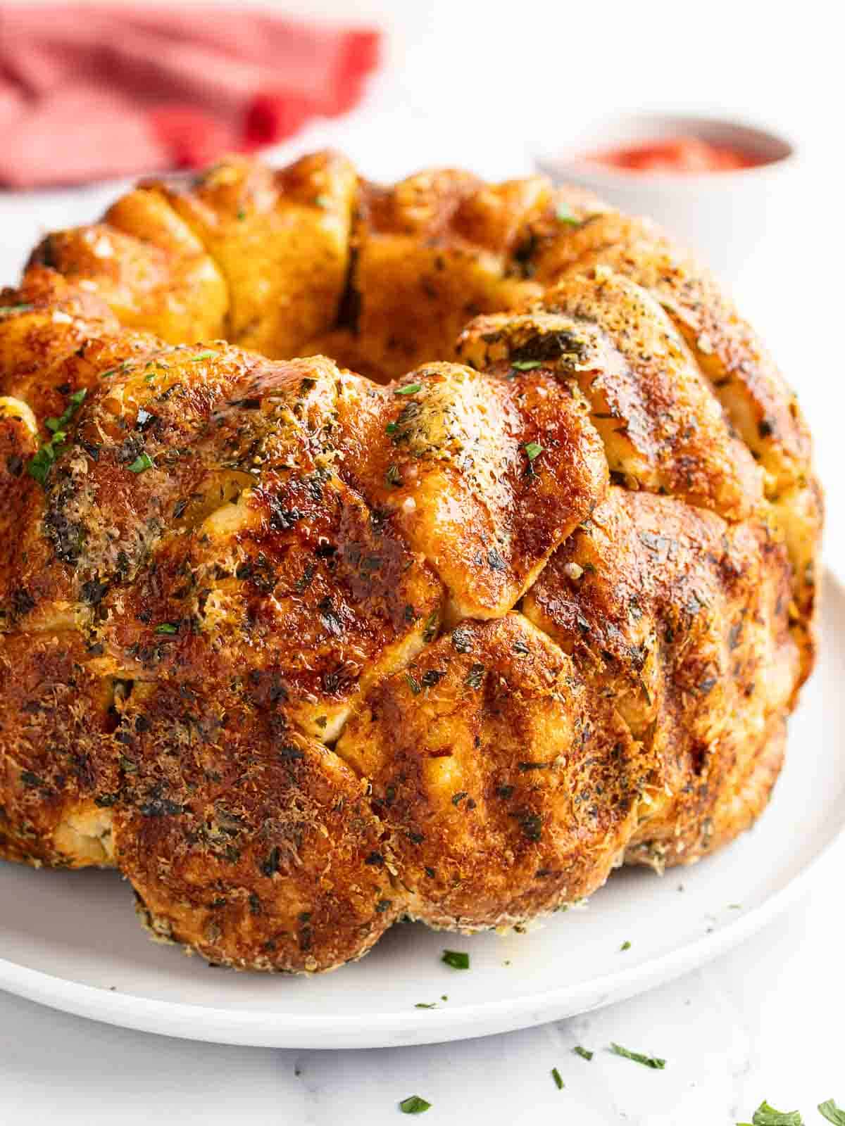 Garlic Monkey Bread baked in a bundt pan turned out onto a plate to serve.