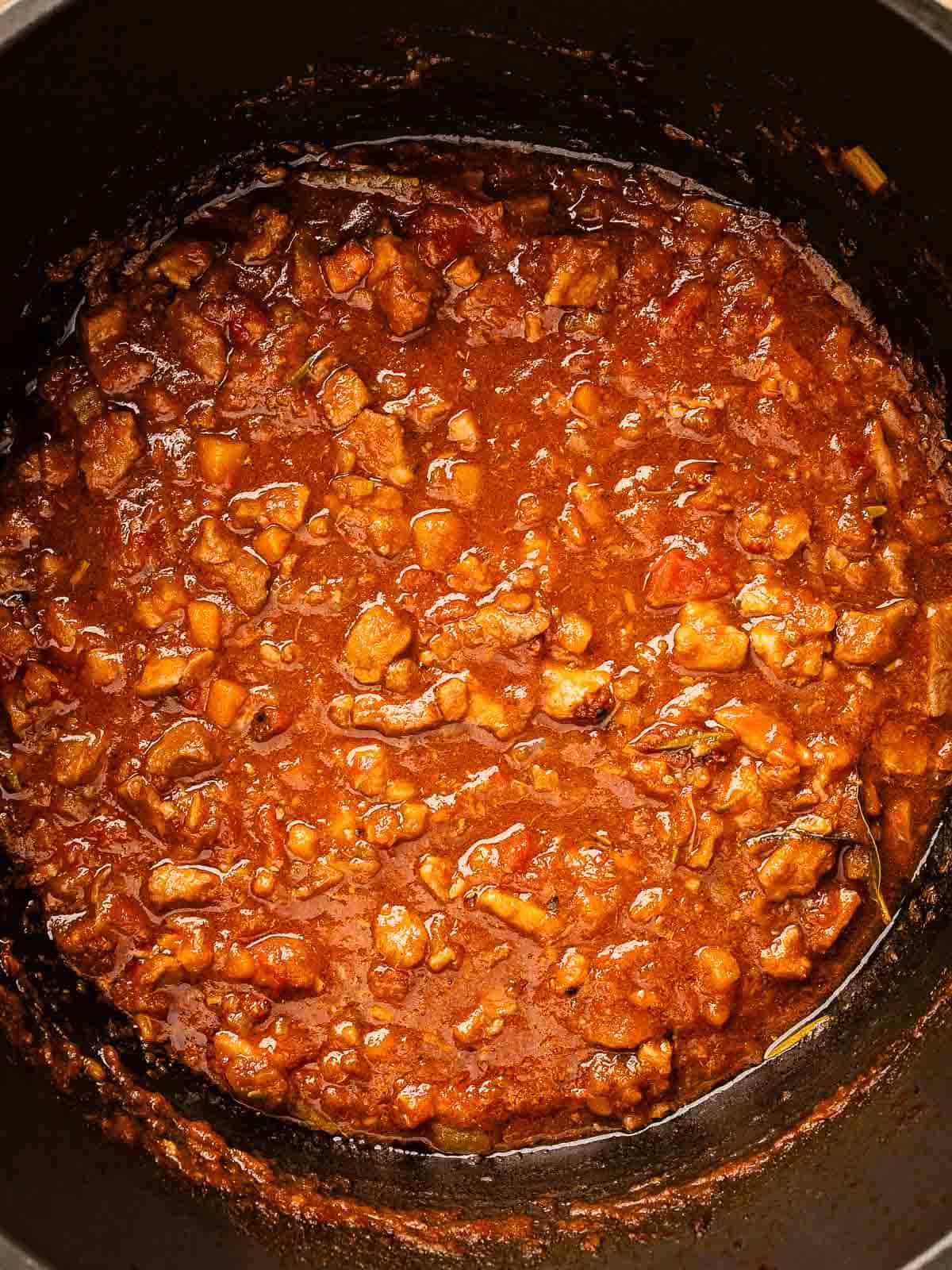 Overhead view of ragu sauce in a pot.