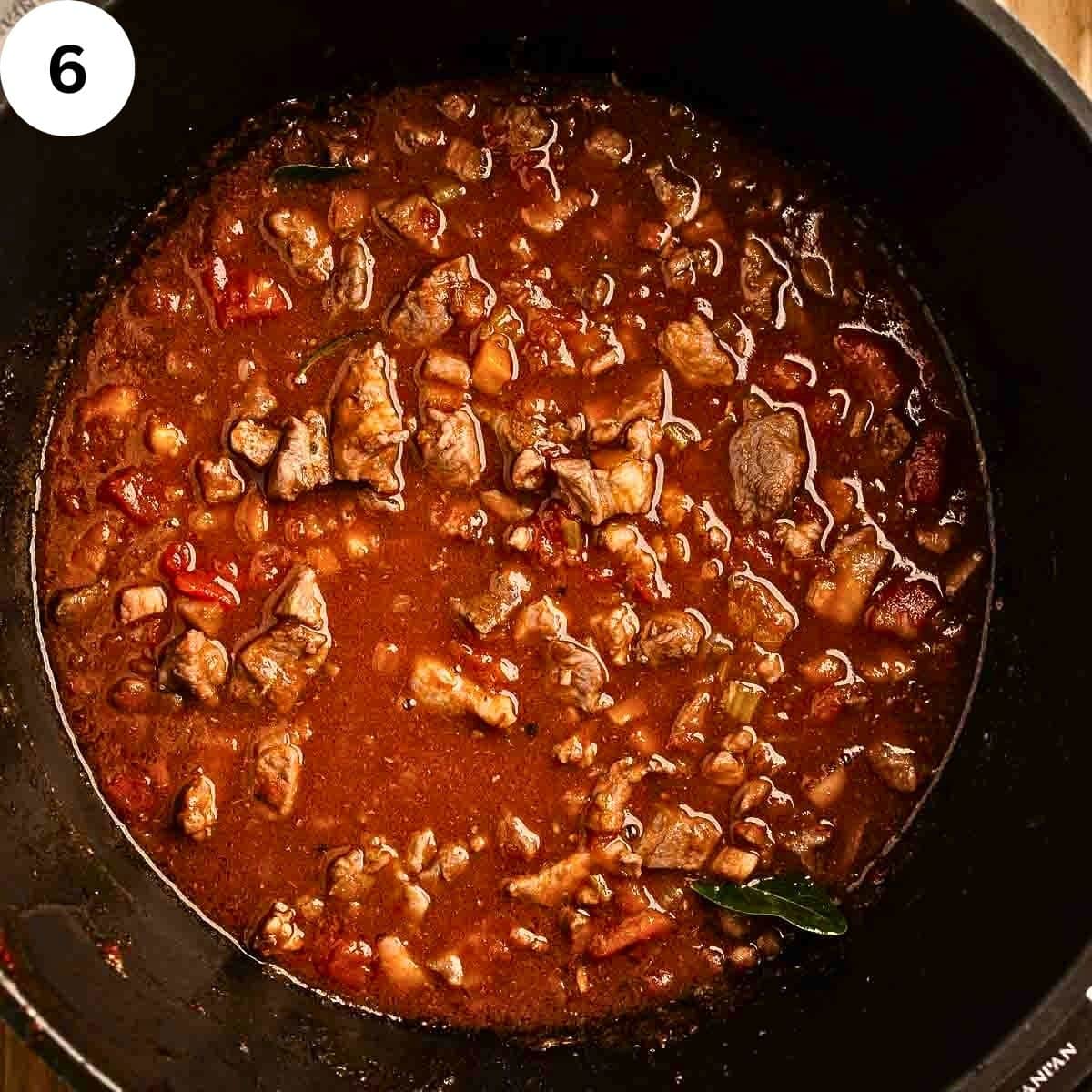 Sauce with meat in a saucepan.