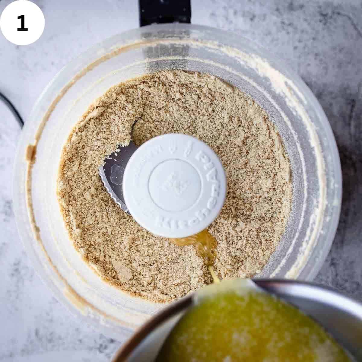 Pouring melted butter into cookie crumbs.