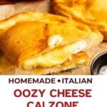 Cheese calzone cut in half and place one on top the the other half showing cheese oozing.