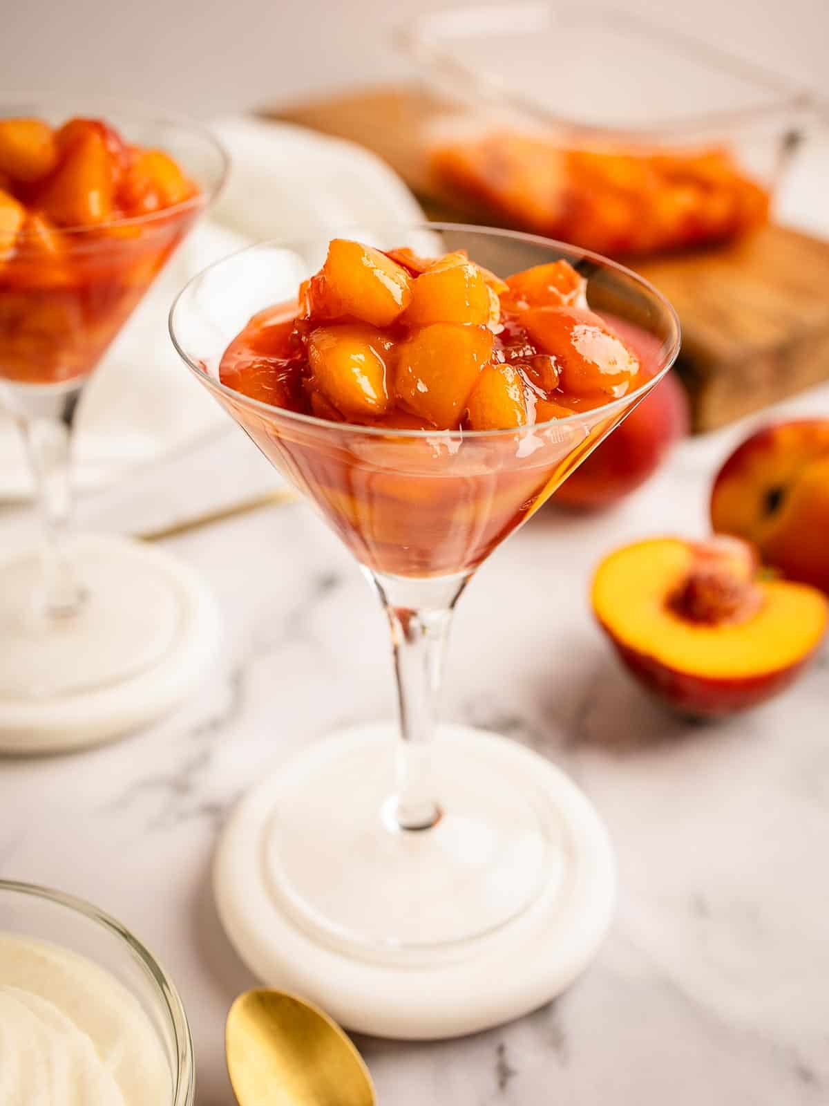 Peach compote in a martini glass.