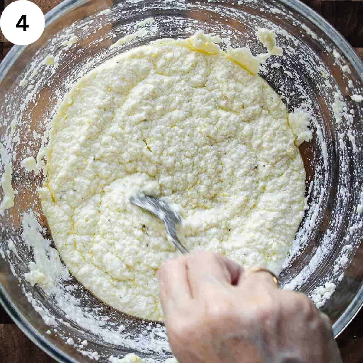 Stirring creamy ricotta cheese mixture.