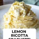 Lemon ricotta spaghetti on a round plate with a sprinkle of lemon zest and Parmesan cheese.
