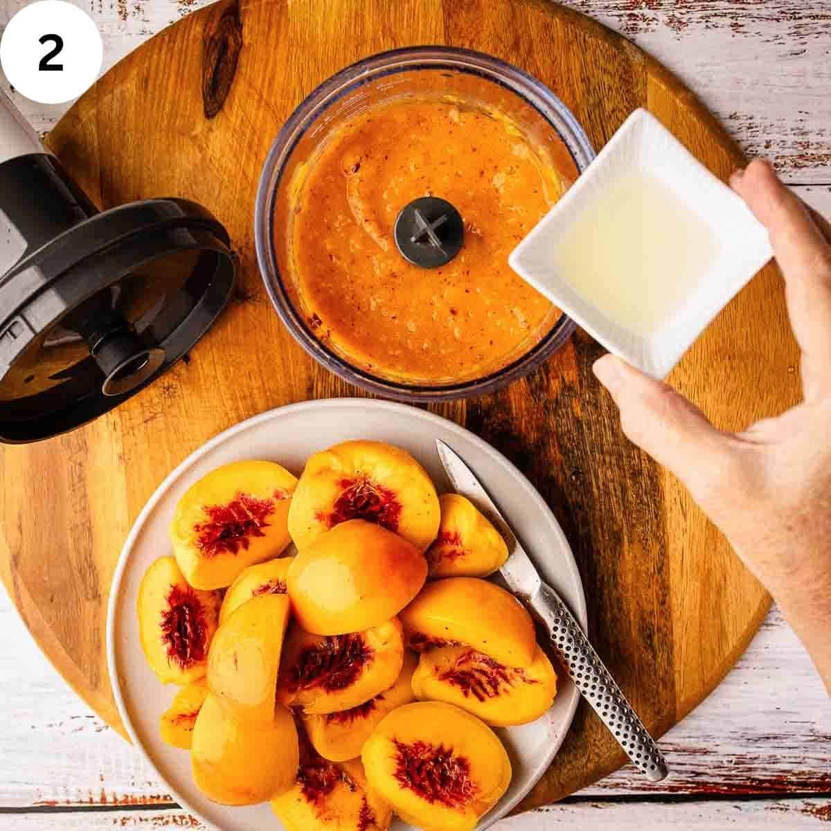 Adding lemon juice to peach puree in a food processor.