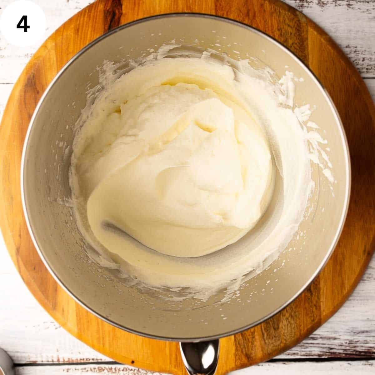Whipped cream in a stainless steel bowl.