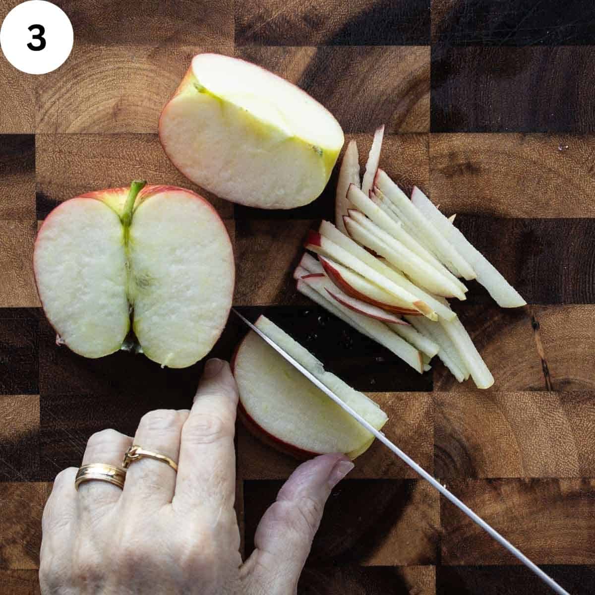 Cutting apple quarters into thin sticks.