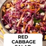 Red Cabbage Salad with red cabbage, grated carrot topped with feta in a round serving bowl.