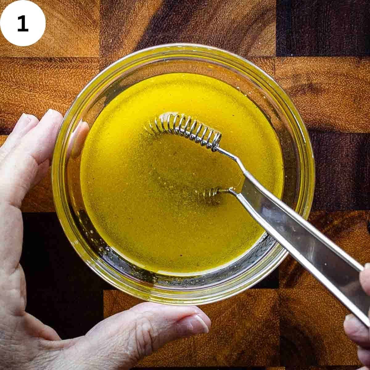 Whisking a salad dressing in a small bowl.
