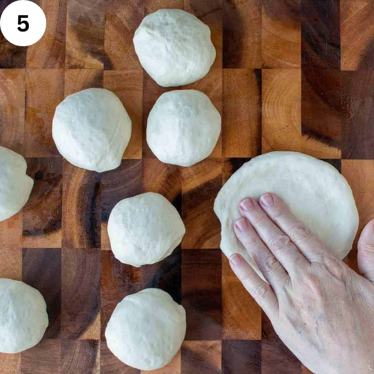 Pressing out balls of dough.