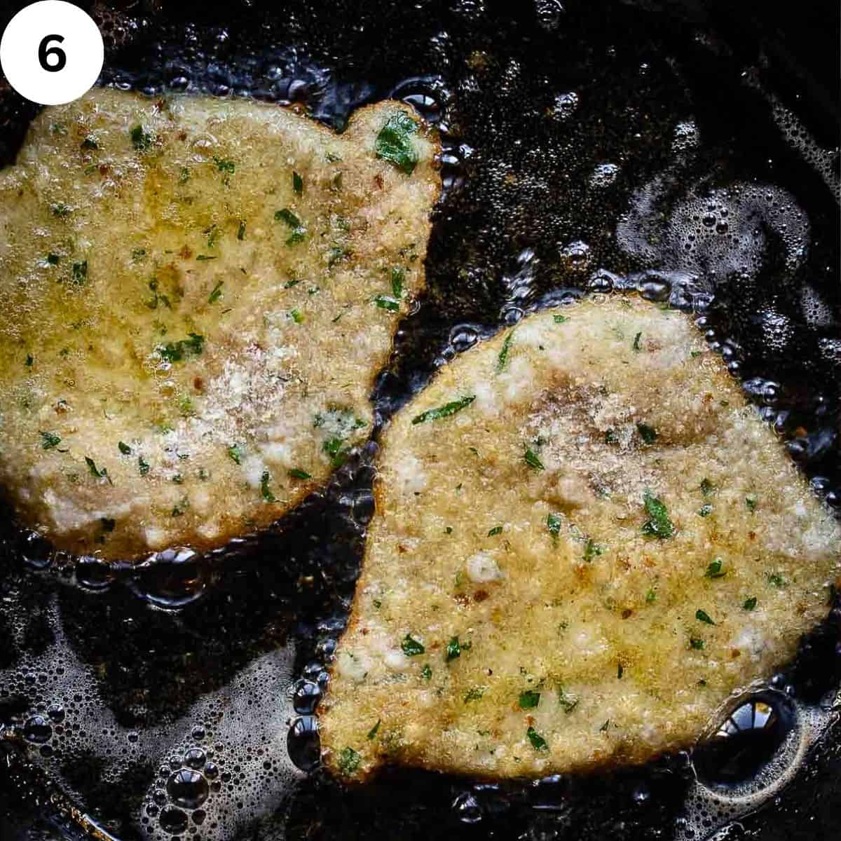 Cutlets frying in a pan in oil.