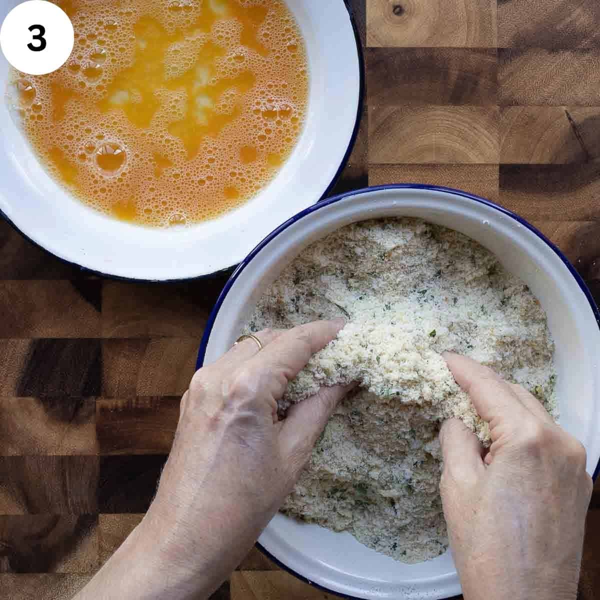 Mixing bread crumbs and seasonings together by hand.