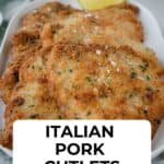 Pork cutlets on a oblong platter, sprinkled with flaked salt, a wedge of lemon and a salad in the background